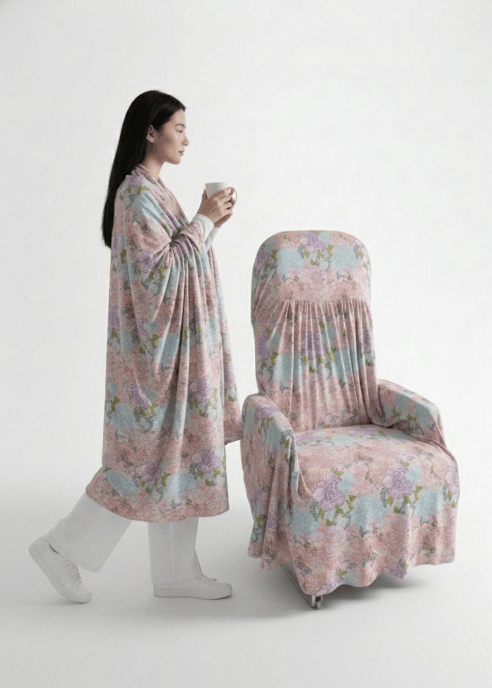 A model wrapping herself in a multi-use sheet as she walks toward a seat protected by a seat cover