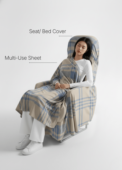 A model sitting comfortably on a seat covered with the travel set seat cover, wrapped in a multi-use sheet, and sleeping — showing a cozy and relaxing travel experience.