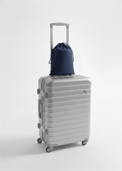 A travel set resting on top of a suitcase.